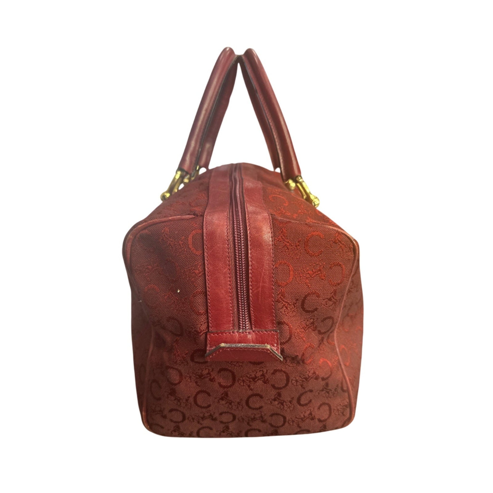 Brown handbag with gold accents on a white background