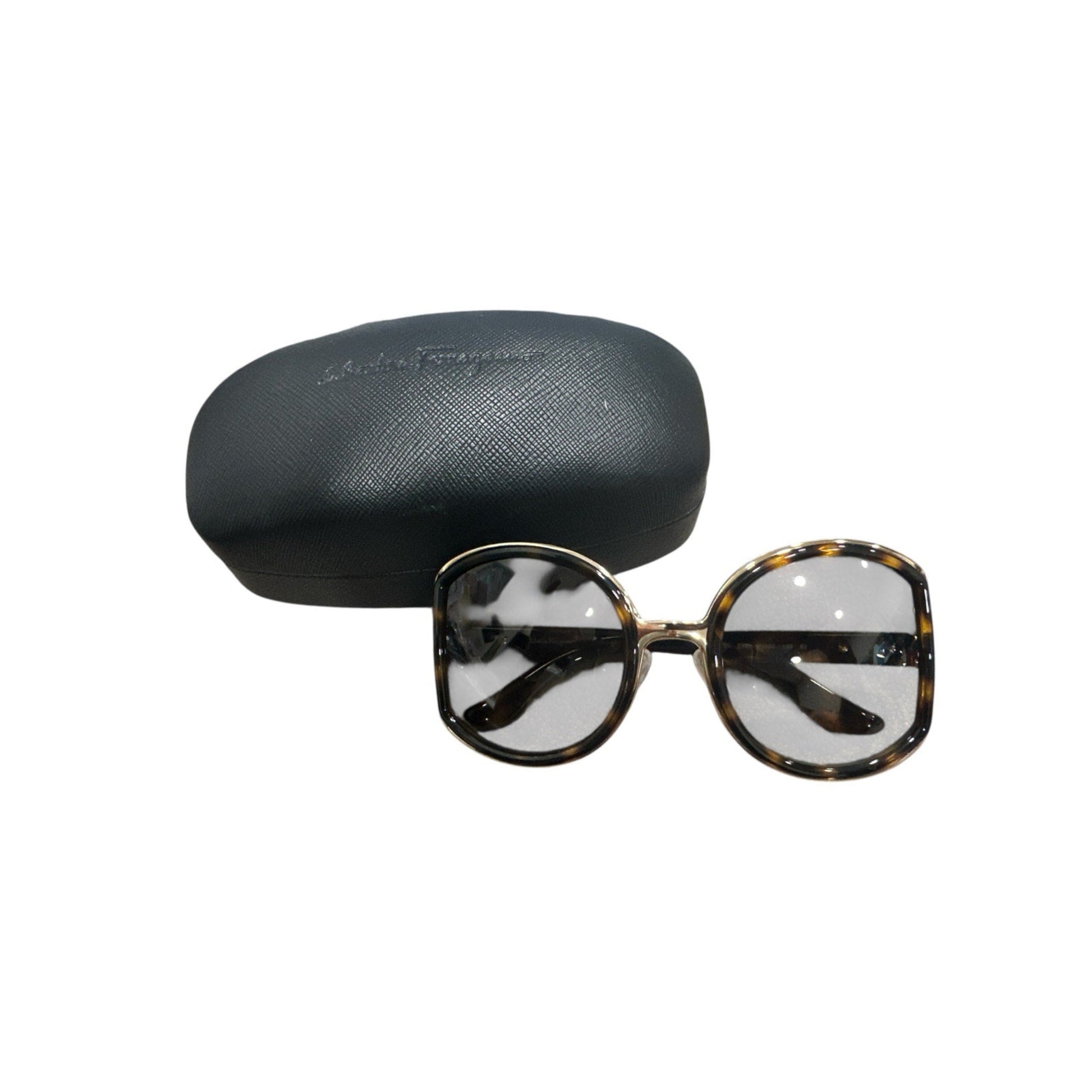 Sunglasses with tortoiseshell frame and clear lenses, accompanied by a black case on a white background.