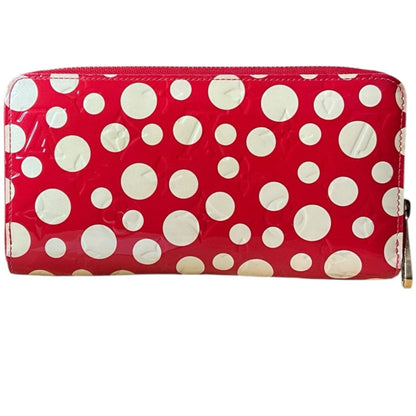 Red wallet with white polka dots on a white background
