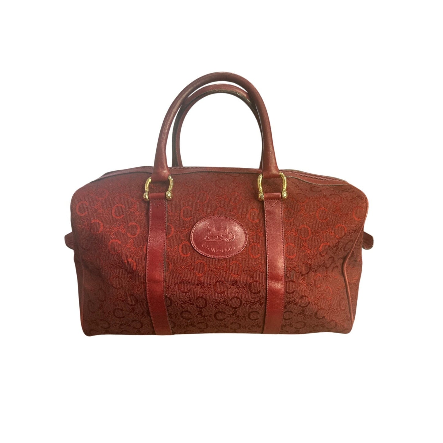 Red leather bag with gold accents on a white background