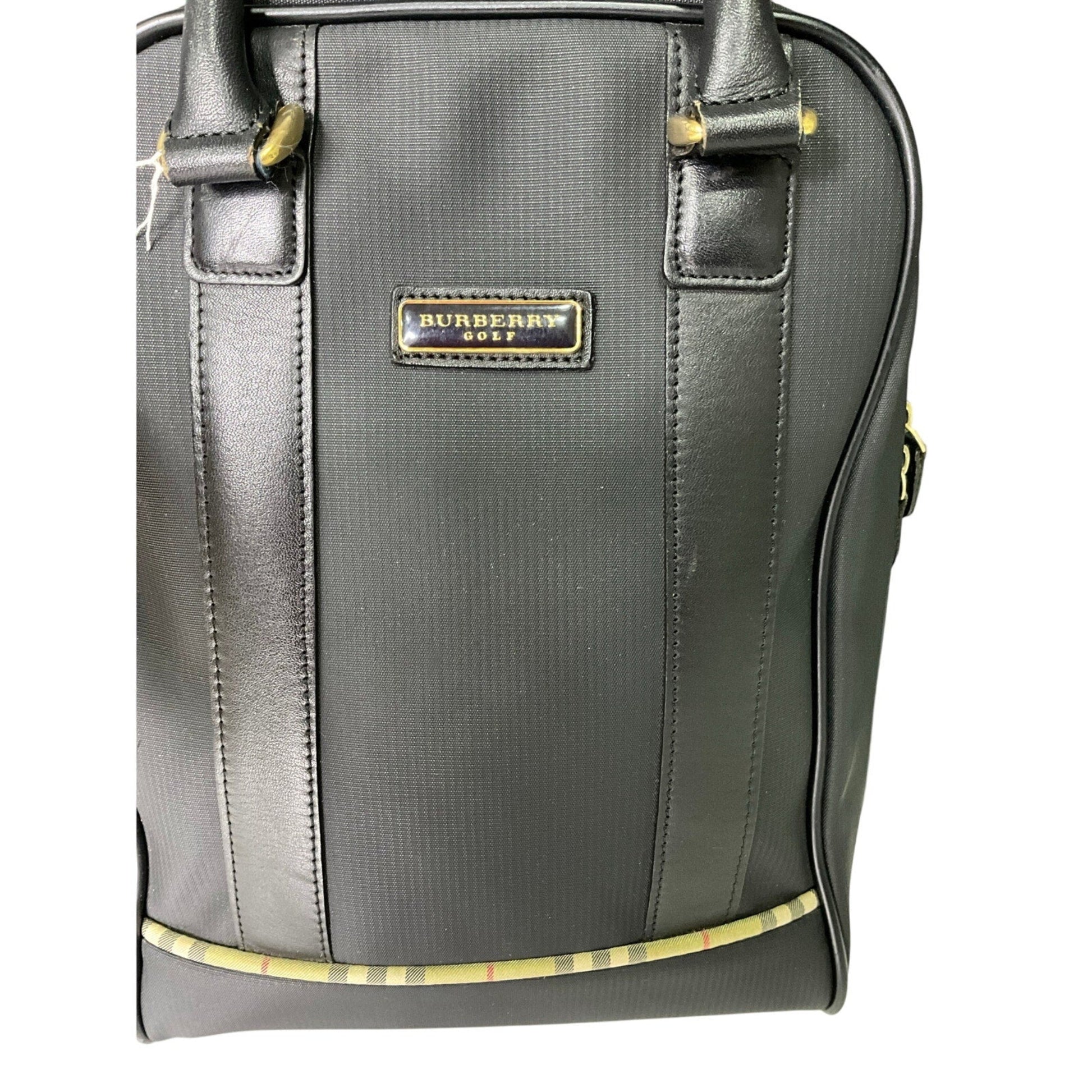 Gray Burberry bag with gold accents on a white background