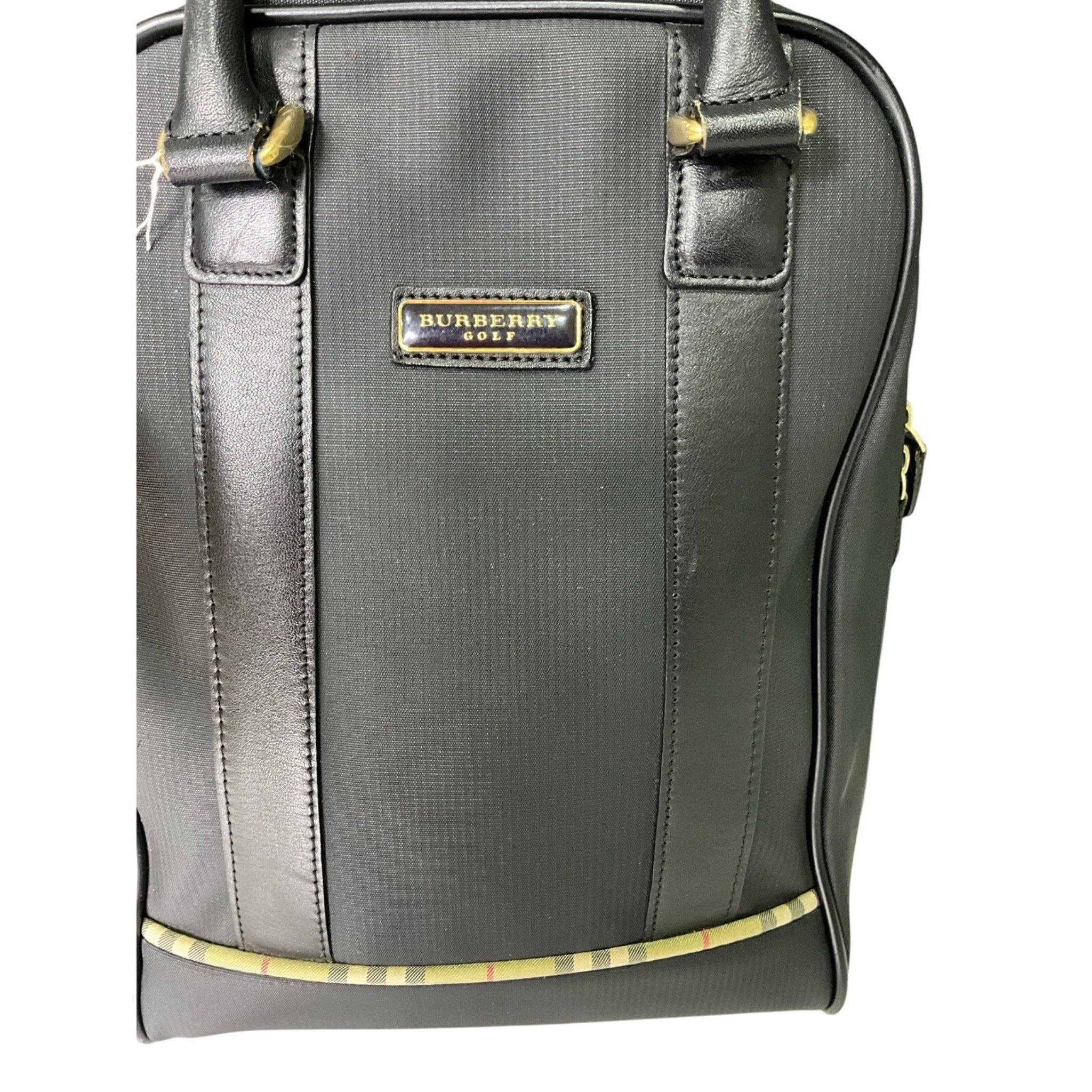 Gray Burberry bag with gold accents on a white background