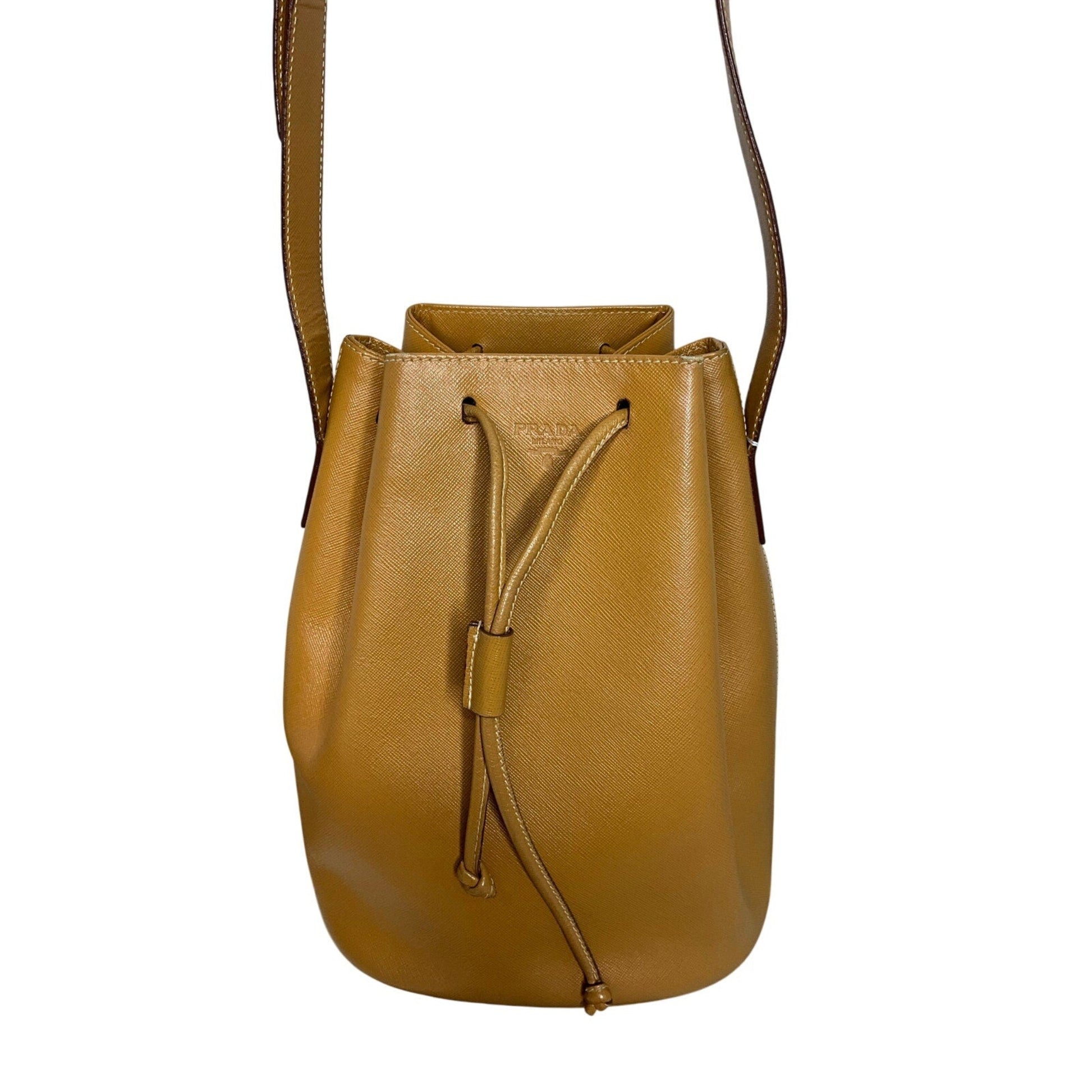 Brown leather bucket bag with drawstring on a white background