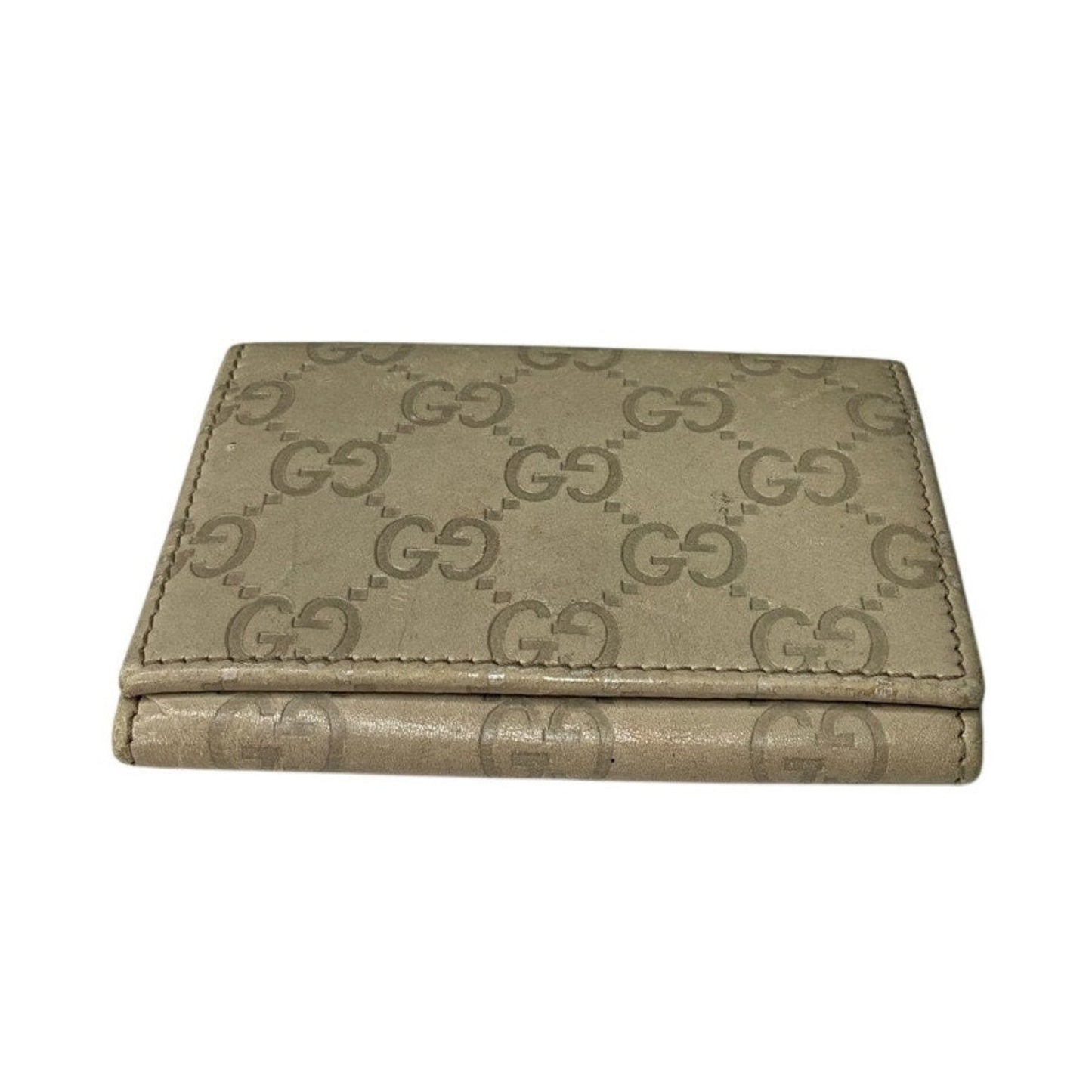Beige wallet with Gucci logo pattern on a white background