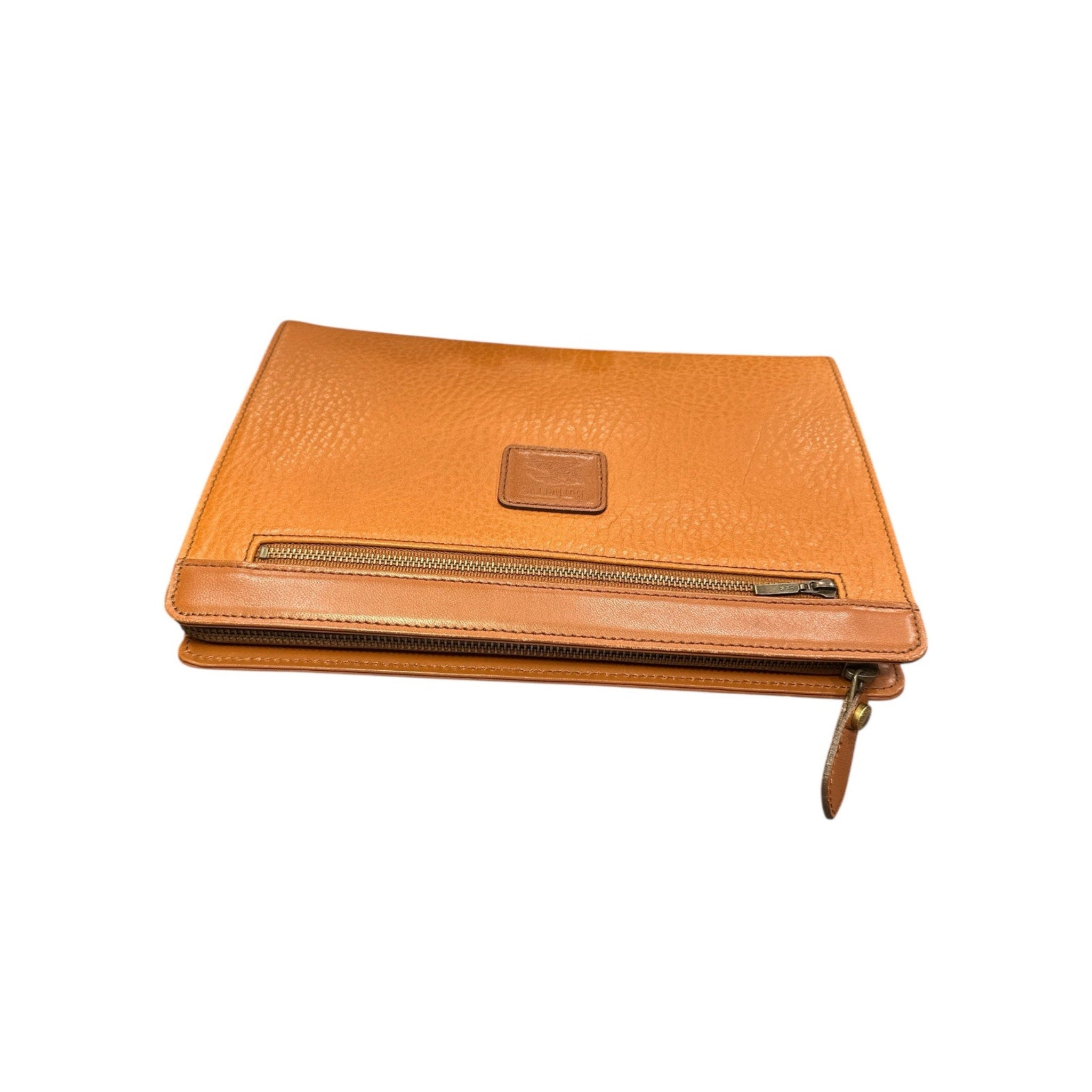 Orange leather clutch bag with a gold zipper on a white background