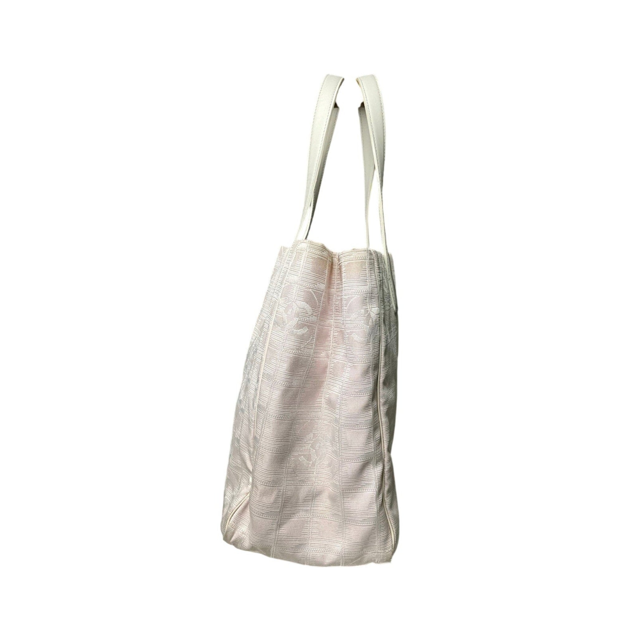 Light-colored tote bag with straps on a white background