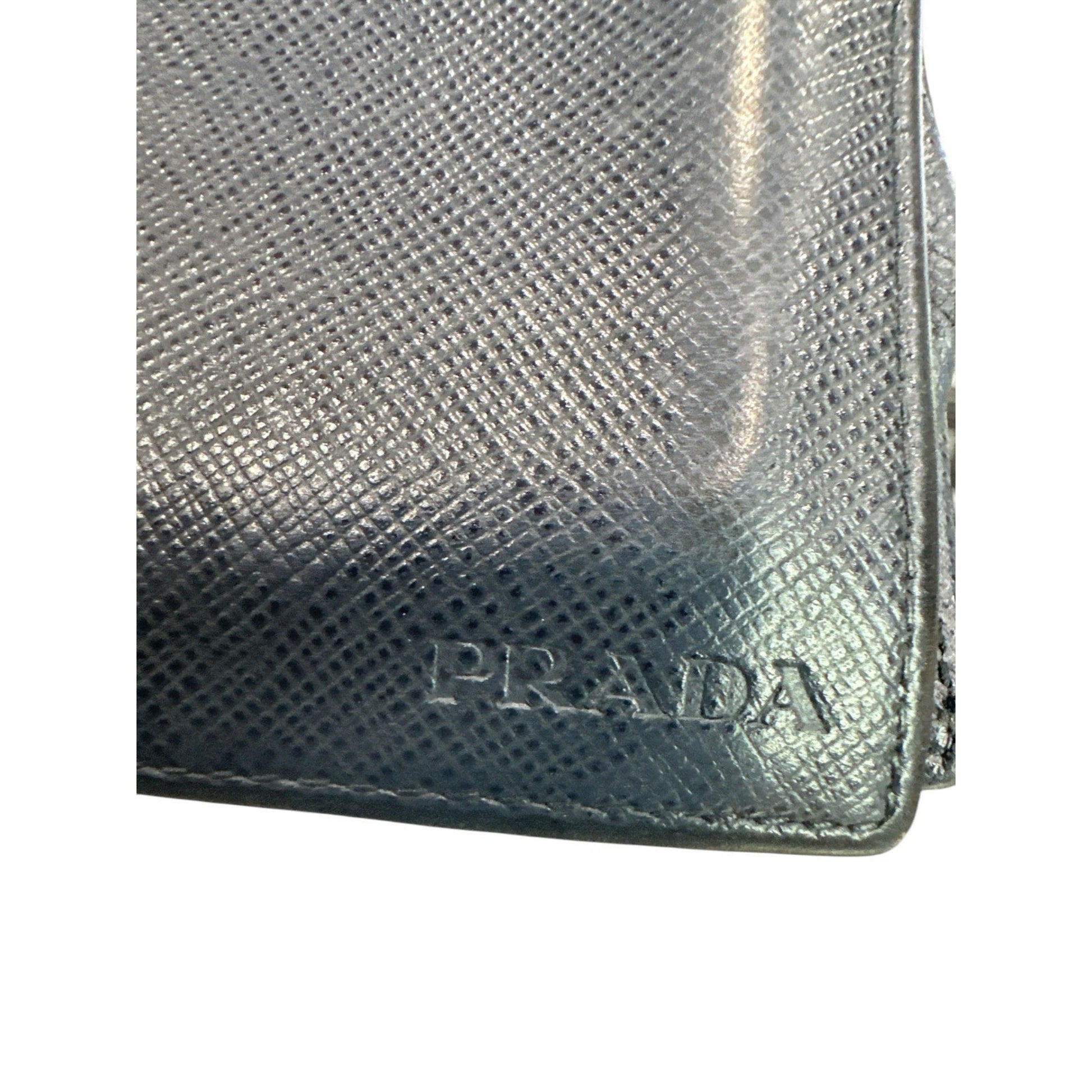 Silver Prada wallet on a white background