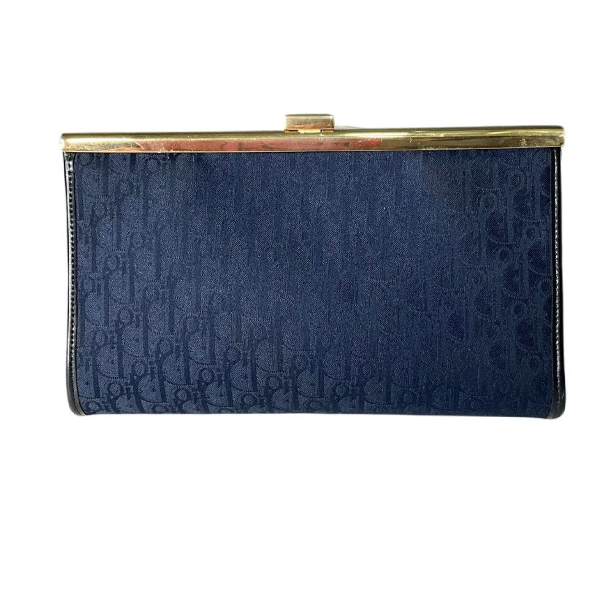 Navy blue clutch bag with gold clasp on a white background