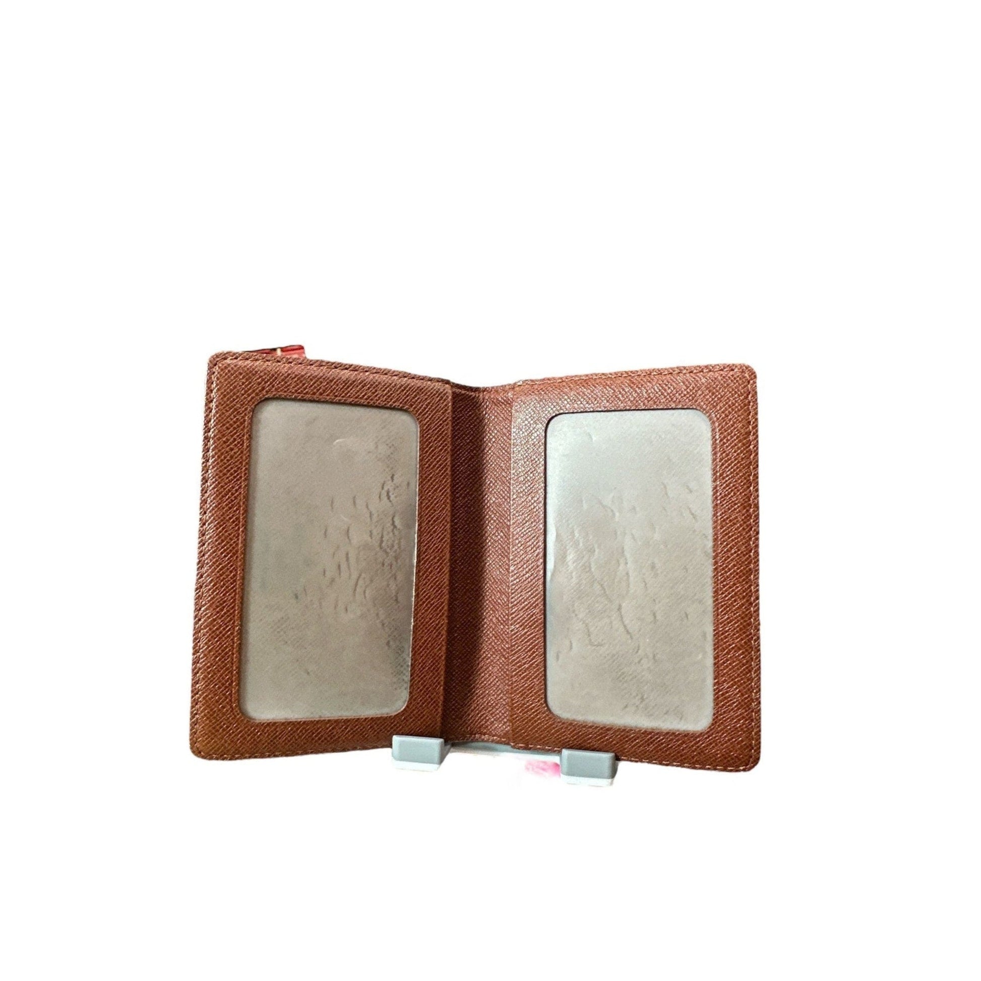 Brown leather wallet with two card slots on a white background