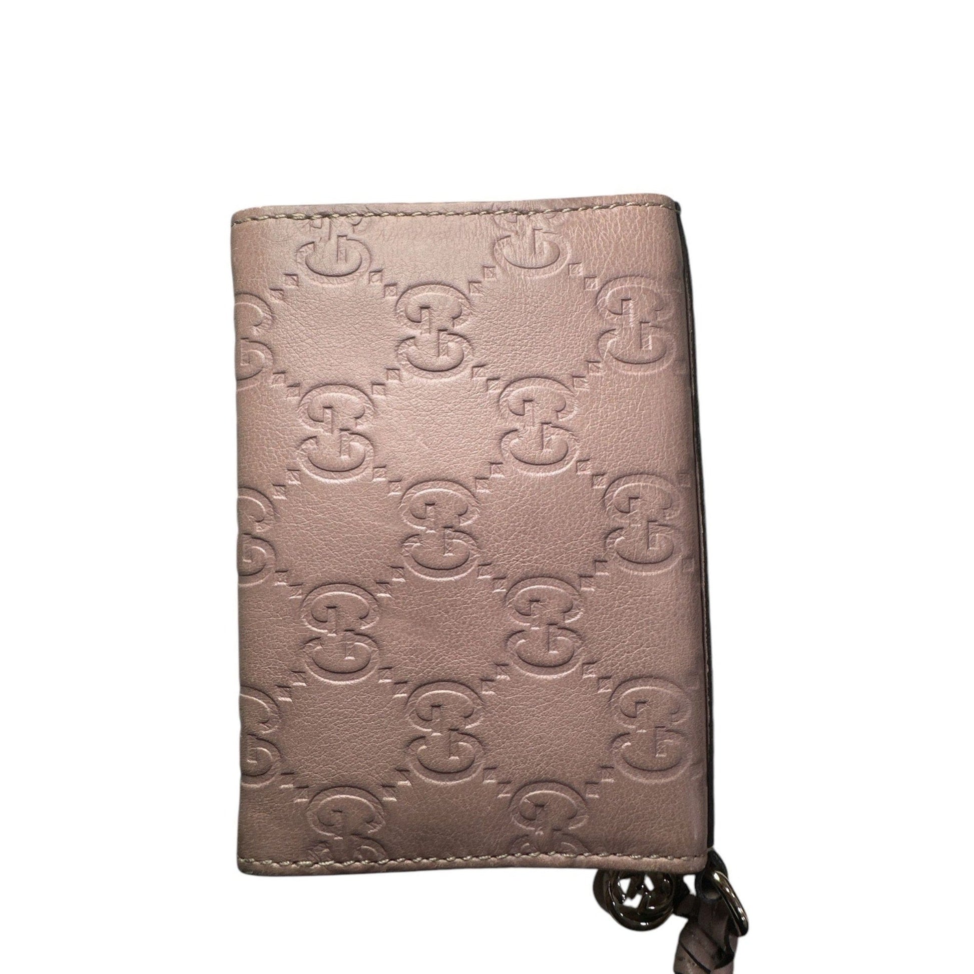 Pink wallet with brand logo pattern on a white background