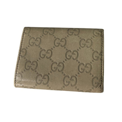 Beige wallet with Gucci logo pattern on a white background