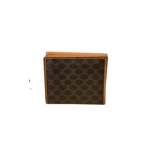 Brown leather wallet with a honeycomb pattern on a white background