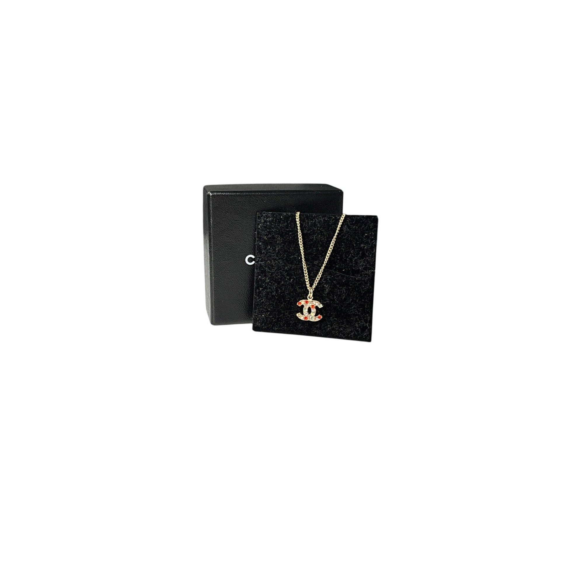 Necklace with a pendant in a black jewelry box on a white background