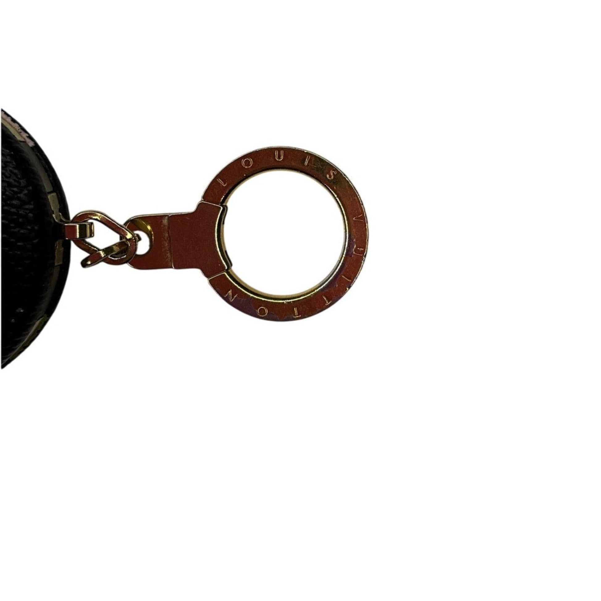 Close-up of a keychain with 'Louis Vuitton' branding on a white background
