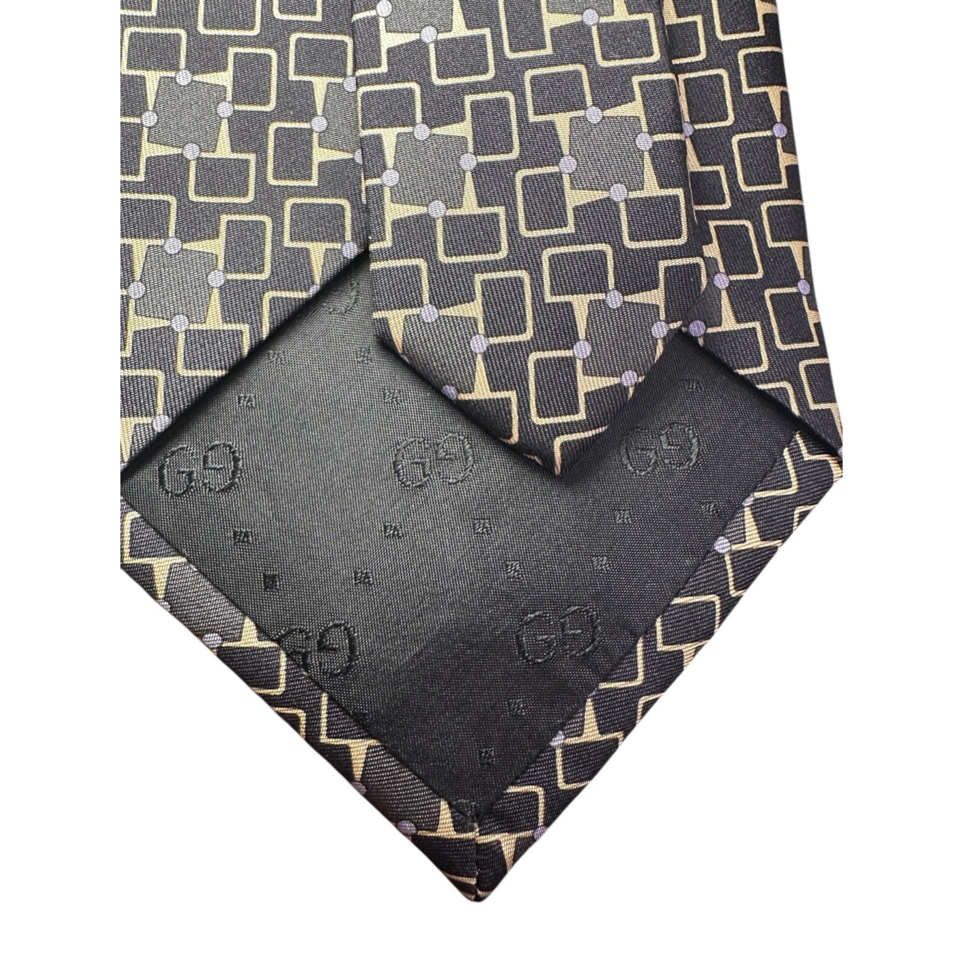 Patterned tie and matching pocket square with Gucci logo on a white background
