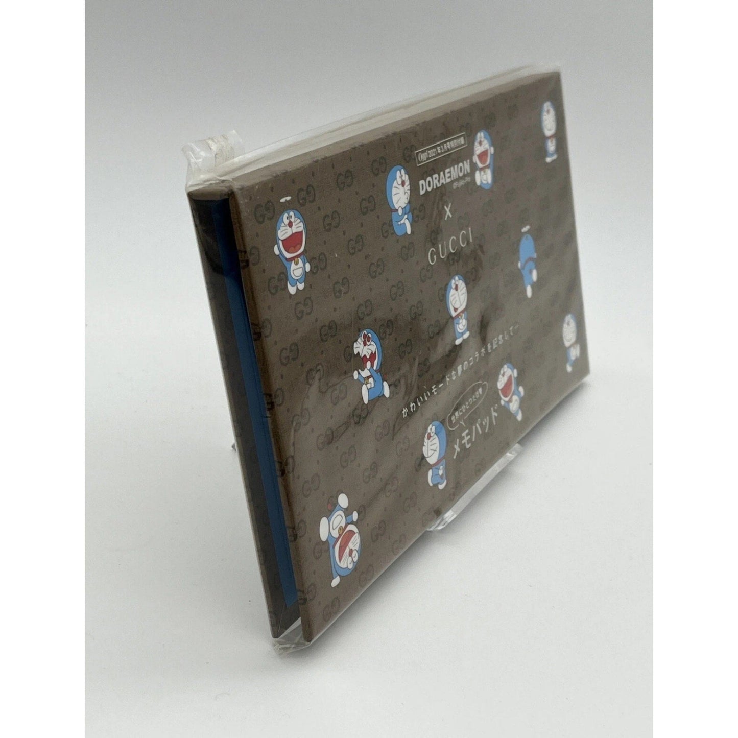 Product packaging with Gucci and Doraemon branding on a gray background