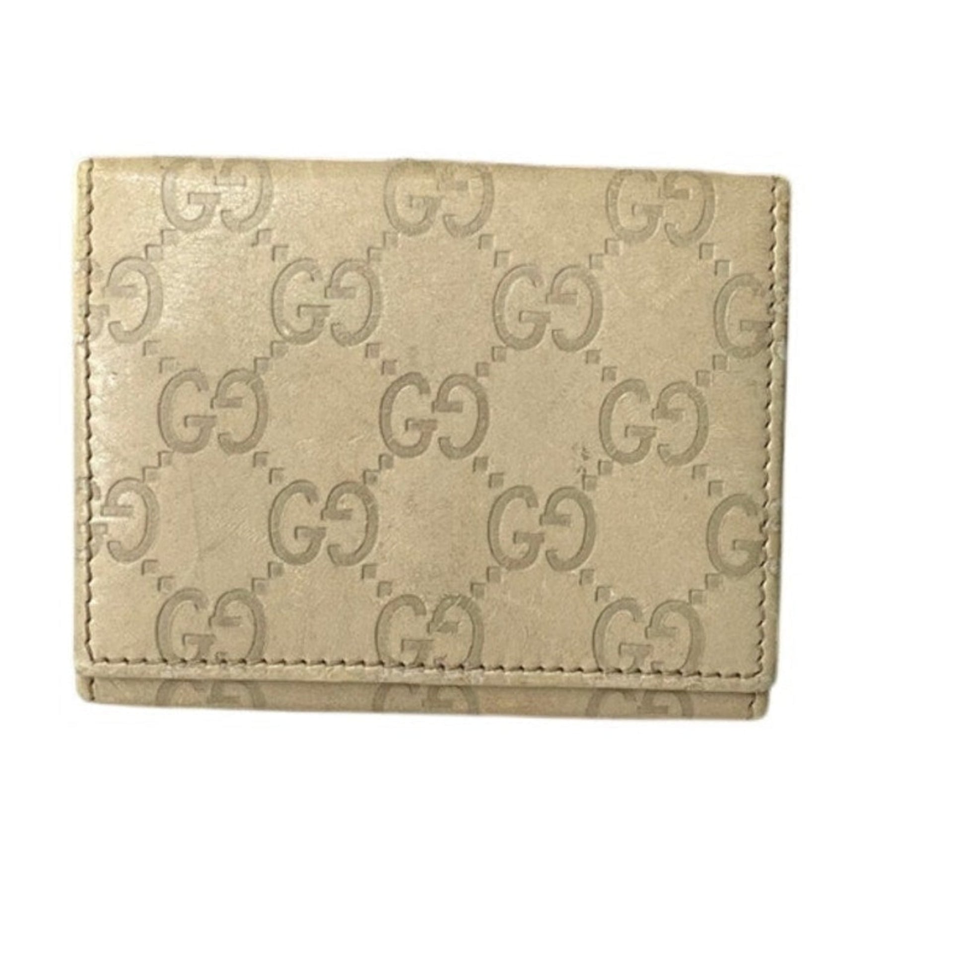 Beige wallet with Gucci logo pattern on a white background