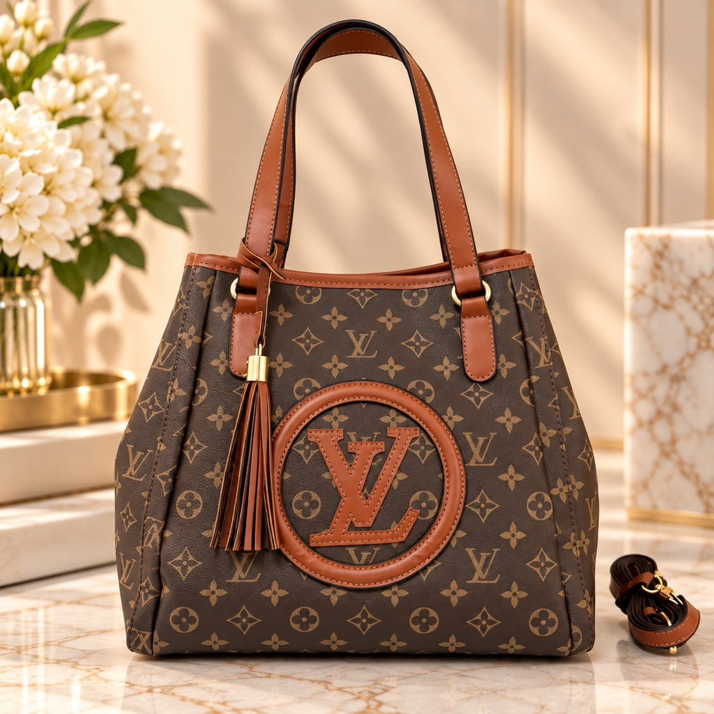 Brown monogram-style fashion tote bag with tan trim and tassel