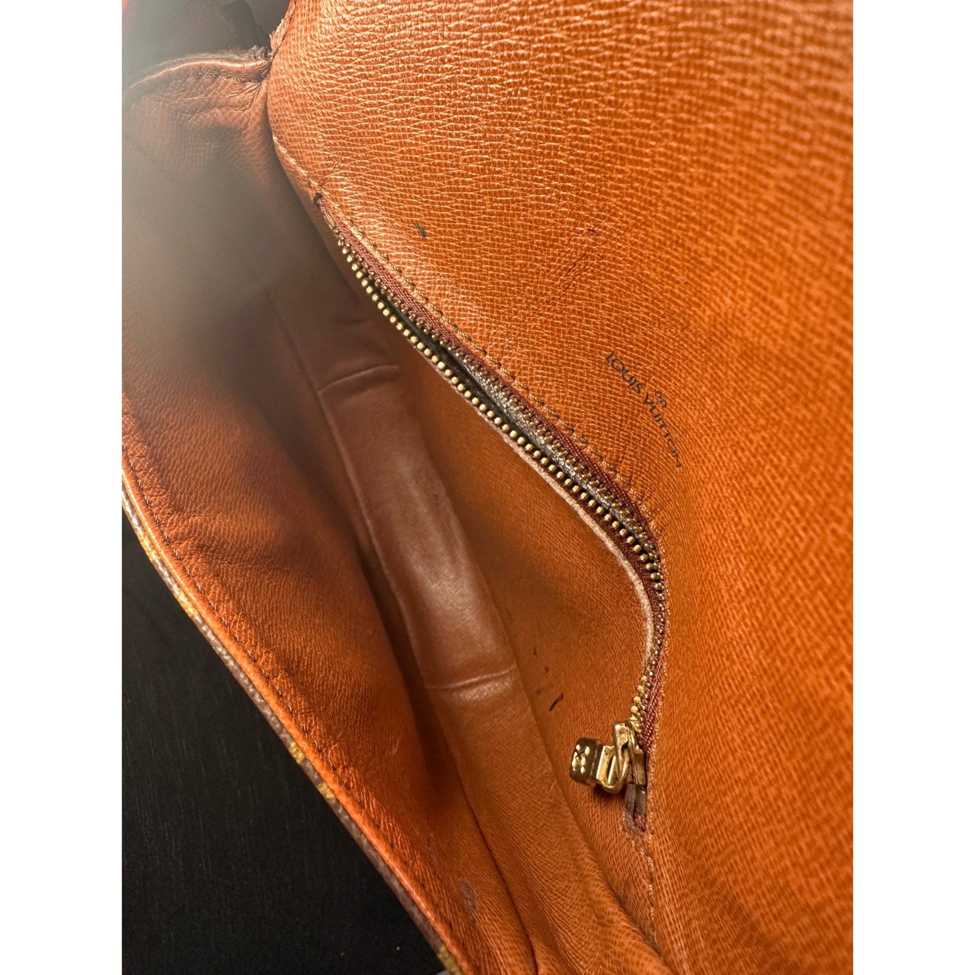 Close-up of a brown leather bag with a zipper