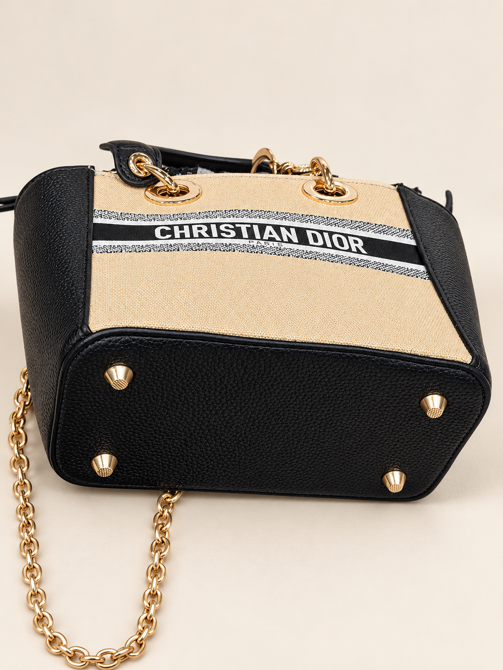 GWP mini bag black textured base with four gold-tone feet